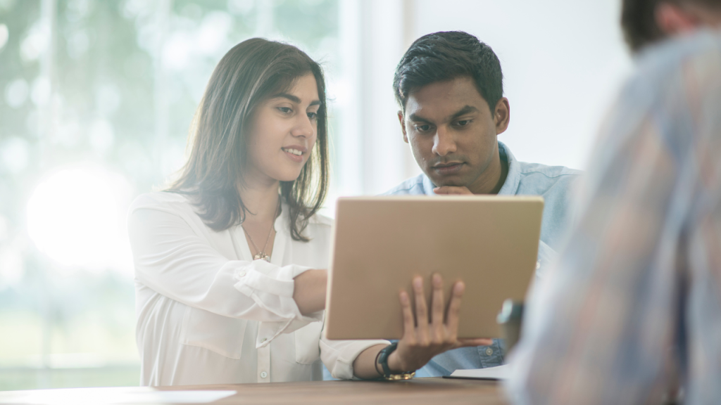 A male employee getting feedback from his female boss.