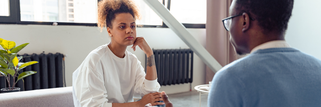 Person calmly listening to constructive feedback from a manager